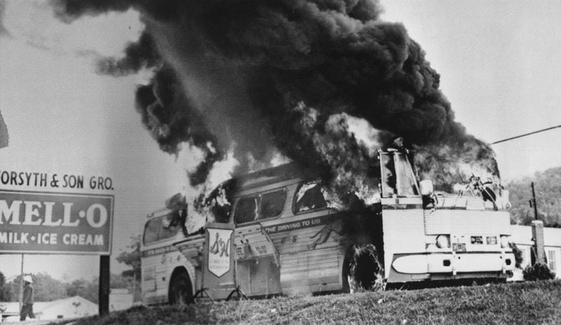 A Freedom Rider bus went up in flames in May 1961 when a fire bomb was tossed through a window near Anniston, Ala. The bus, which was testing bus station segregation in the south, had stopped because of a flat tire. Passengers escaped without serious injury.(AP Photo)