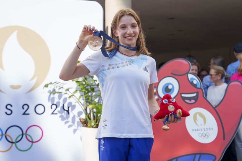 Romanian gymnast Ana Barbosu poses with the bronze medal for her women's artistic gymnastics individual floor performance at the Paris 2024 Olympics, after receiving it during a ceremony at the Romanian Olympic and Sports Committee, in Bucharest, Romania, Friday, Aug. 16, 2024. American gymnast Jordan Chiles called an arbitration panel's decision that dropped her out of the bronze medal position in the floor exercise at the Paris Olympics "unjust" and a "significant blow" in a message posted on social media Thursday. (AP Photo/Vadim Ghirda)