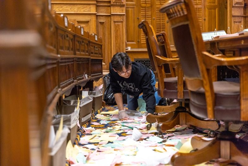 An employee of ICS Cleaners cleans the Senate after the legislative session in Atlanta on Sine Die, Wednesday, March 29, 2023. (Arvin Temkar /The Atlanta Journal-Constitution)