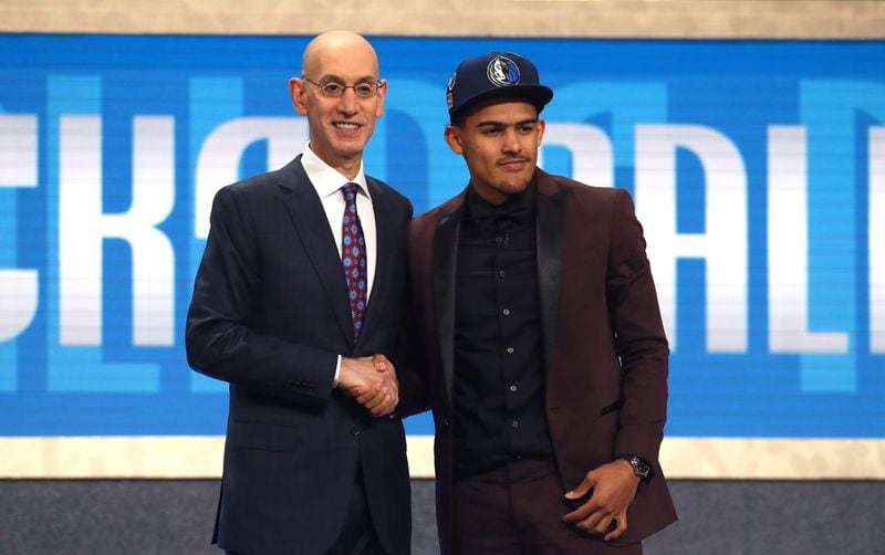 Trae Young (wearing a Dallas Mavericks cap) on draft night in 2018 with NBA commissioner Adam Silver. Young was part of a draft-night trade which ultimately landed him in Atlanta.