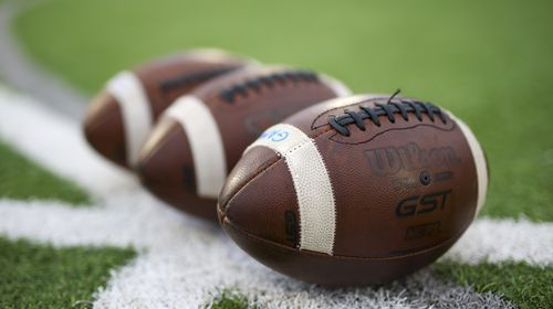 Three footballs are shown before the game between Peachtree Ridge and North Gwinnett at North Gwinnett high school, Friday, October 13, 2023, in Suwanee, Ga. (Jason Getz / Jason.Getz@ajc.com)