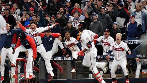 10/30/21 - Atlanta - Atlanta Braves players and fans react after pinch hitter Jorge Soler hit a solo home run to put the Braves up 3-2 against the Houston Astros during the seventh inning of game 4 in the World Series at Truist Park, Saturday October 30, 2021, in Atlanta Hyosub Shin / Hyosub.Shin@ajc.com