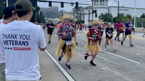 Delta Air Lines employees cheer on runners at the AJC Peachtree Road Race in 2022, part of the airline's decades-long involvement in the race. Courtesy of Delta