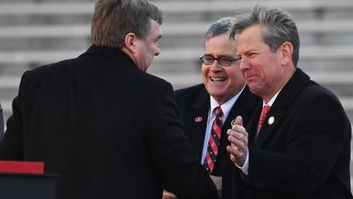 Georgia coach Kirby Smart (left) is greeted by UGA President Jere Morehead (center) and Governor Brian Kemp during the celebration of the Bulldogs going back-to-back to win the 2022 National Championship at Sanford Stadium, Saturday, Jan. 14, 2023, in Athens. (Hyosub Shin / Hyosub.Shin@ajc.com)