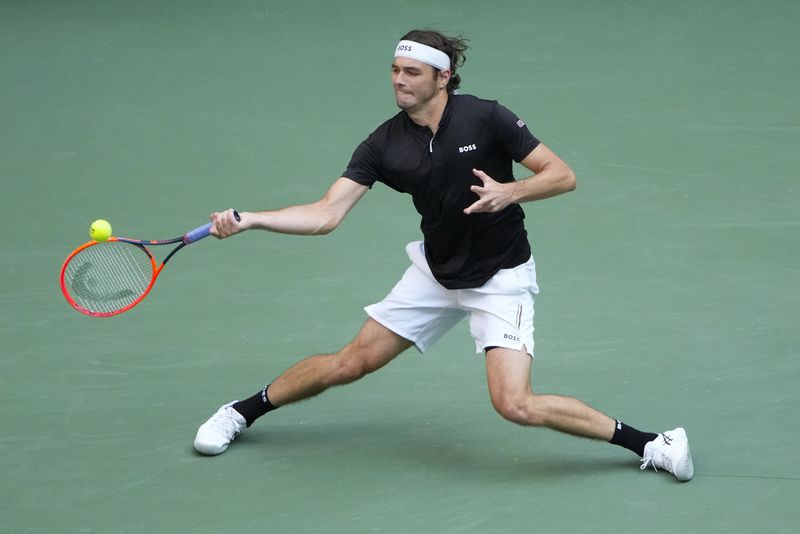 Taylor Fritz, of the United States, returns a shot to Alexander Zverev, of Germany, during the quarterfinals of the U.S. Open tennis championships, Tuesday, Sept. 3, 2024, in New York. (AP Photo/Pamela Smith)