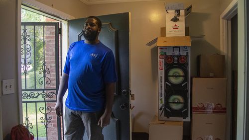 Joshua Elam stands near packed boxes full of his belongings at his residence in Decatur. Elam is facing eviction from the house he has been renting for two years. (Alyssa Pointer/Atlanta Journal Constitution)