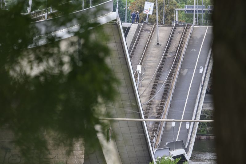 Parts of the Carola Bridge over the Elbe is seen collapsed in Dresden, eastern Germany, Wednesday, Sept. 11, 2024. (Robert Michael/dpa via AP)