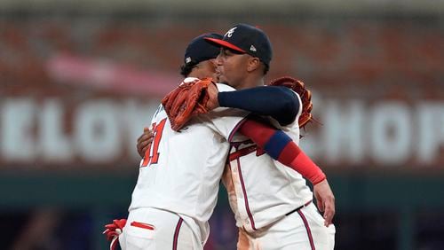 Atlanta Braves second base Ozzie Albies, right, and shortstop Orlando Arcia celebrate after defeating Detroit Tigers in a baseball game Tuesday, June 18, 2024, in Atlanta. (AP Photo/John Bazemore)