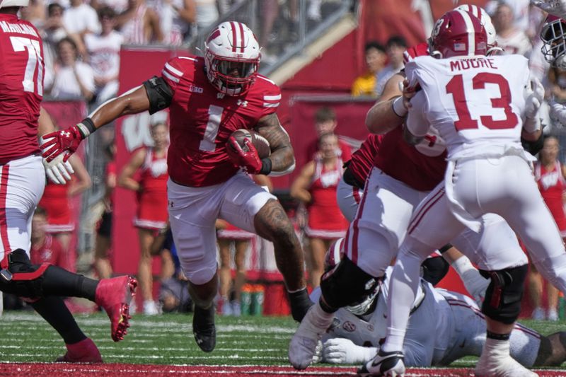 Wisconsin's Chez Mellusi (1) runs during the first half of an NCAA college football game against Alabama Saturday, Sept. 14, 2024, in Madison, Wis. (AP Photo/Morry Gash)