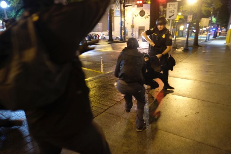 Protesters and police face off in downtown Atlanta Tuesday evening.