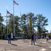 10/6/2020 - Stone Mountain, Georgia - Individuals stand at a distance from one another while participating in a Stone Mountain Action Coalition Òprayer for our parkÓ event at the flag terrace at the Stone Mountain walk-up trail in Stone Mountain, Tuesday, October 6, 2020. Faith leaders gathered and prayed for peace, compassion, healing, integrity, endurance, love and understanding for hopes of bringing change to Stone Mountain Park. ÒAs the [Stone Mountain] Park continues to serve as a rally point for hate groups and violence, SMAC believes it is more important than ever to demonstrate the desperate need for peace and extraordinary opportunity it has to serve as a place of unity,Ó said a flyer give out by the Stone Mountain Action Coalition. (Alyssa Pointer / Alyssa.Pointer@ajc.com)