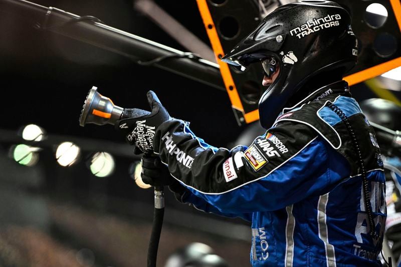 A pit crew member for Chase Briscoe prepares for a pit stop during a NASCAR Cup Series auto race at Darlington Raceway, Sunday, Sept. 1, 2024, in Darlington, S.C. (AP Photo/Matt Kelley)