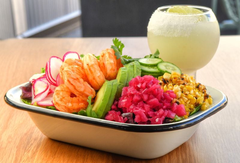 Azotea Salad (mixed lettuces, grilled sweet corn, Chihuahua cheese, pickled red onions, radish, cucumbers, tortilla strips and citrus chipotle dressing), shown with a shrimp addition, and Azotea Margarita cocktail. (Chris Hunt for The Atlanta Journal-Constitution)