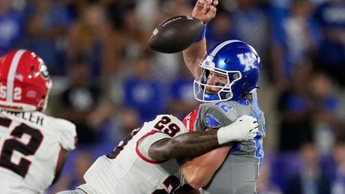 Kentucky quarterback Brock Vandagriff fumbles as he's hit by Georgia linebacker Gabe Harris Jr. (29) during the first half of an NCAA college football game, Saturday, Sept. 14, 2024, in Lexington, Ky. (AP Photo/Darron Cummings)