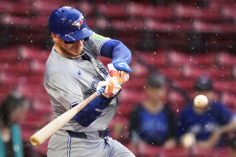 Toronto Blue Jays' Danny Jansen takes swings on a pitch shortly before the game was delayed during his at-bat due to heavy rain in the first inning of a baseball game at Fenway Park, Wednesday, June 26, 2024, in Boston. Jansen, who was traded by the Blue Jays to the Red Sox on July 27th, is scheduled to be in the line-up against his former team when the delayed game continues on Aug. 26, 2026. Jansen would become the first major league player to appear in the same game for both teams. (AP Photo/Charles Krupa, File)