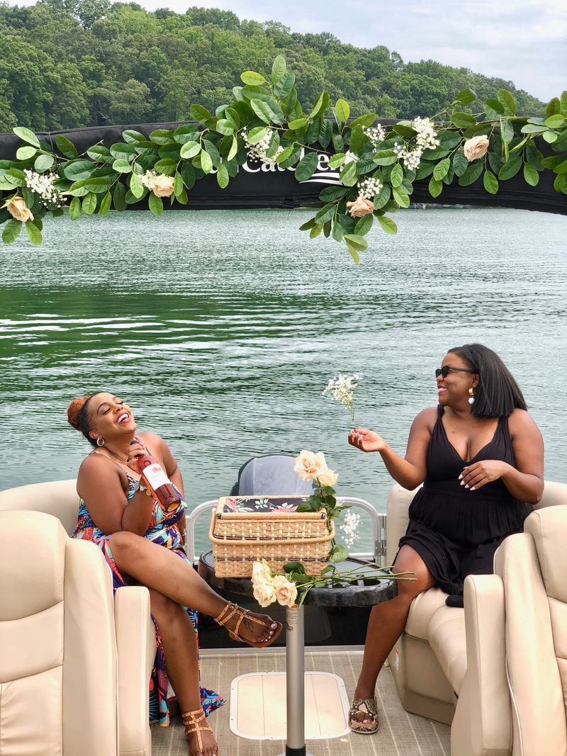 Candis Harris, (left) and Daniele Mays took a mid-July boat ride on Lake Lanier. Mays is an event coordinator and said the COVID-19 pandemic has forced her to plan outdoor only events. Though she and Harris took their masks off for this picture, Mays said she and the other eight people onboard wore them most of the time for the party.