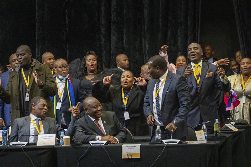 African National Congress lawmakers and South African président Cyril Ramaphosa react after his being reelected as leader of the country in Cape Town, South Africa, Friday, June 14, 2024. (AP Photo/Jerome Delay)