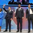 Conservative leadership candidates Kemi Badenoch, from left, Robert Jenrick, James Cleverly and om Tugendhat stand on the podium during the Conservative Party Conference at the International Convention Centre in Birmingham, England, Wednesday, Oct. 2, 2024.(AP Photo/Kin Cheung)