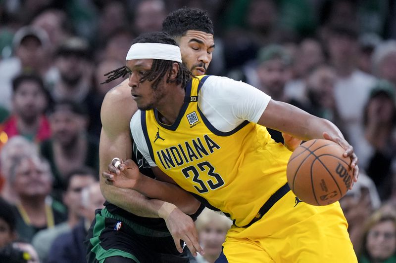 Indiana Pacers center Myles Turner (33) is defended by Boston Celtics forward Jayson Tatum during the second half of Game 2 of the NBA Eastern Conference basketball finals Thursday, May 23, 2024, in Boston. (AP Photo/Steven Senne)