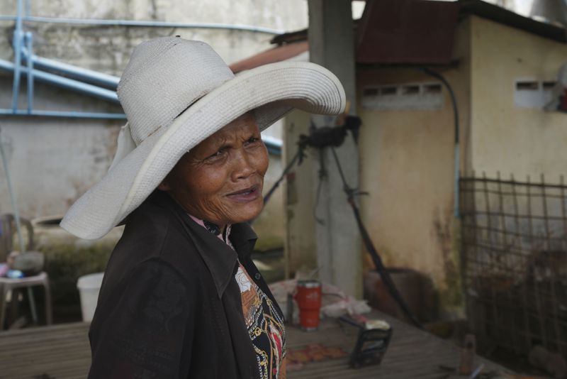 Sok Koeun, a villager who lives along the Funan Techo Canal, is interviewed by The Associated Press at her home at Prek Takeo village, eastern Phnom Penh Cambodia, Tuesday, July 30, 2024. (AP Photo/Heng Sinith)