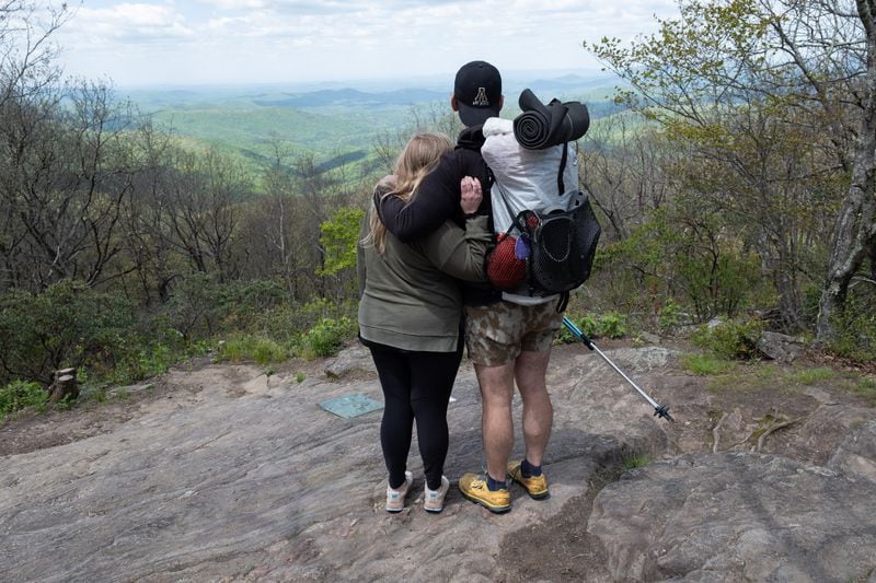 Zach Cross hugs his wife Grayson on the top of Springer Mountain at the Southern Terminus of the Appalachian Trail on Monday just before he started his Appalachian Trail thru-hike.  (Ben Gray / Ben@BenGray.com)