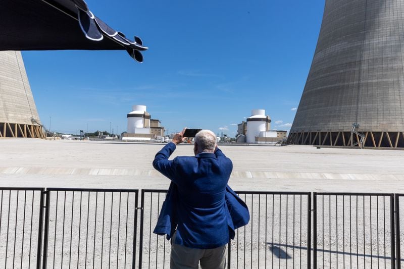 Merv Waldrop, county manager for Burke County, takes a photo of the new units at a ceremony celebrating the completion of the Unit 3 and 4 expansion at Plant Vogtle, operated by Georgia Power Co., in east Georgia's Burke County near Waynesboro, on Wednesday, May 29, 2024. (Arvin Temkar / AJC)