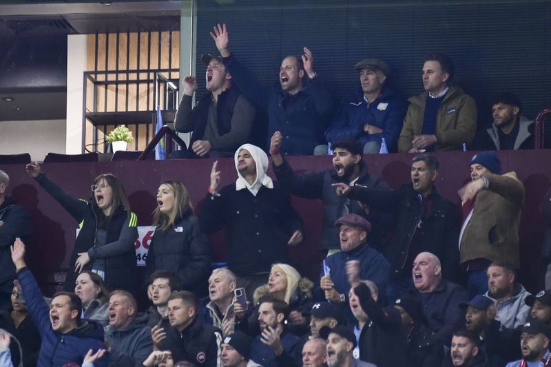 Britain's Prince William, second left in back row, reacts during the Champions League opening phase soccer match between Aston Villa and Bayern Munich, at Villa Park in Birmingham, England, Wednesday, Oct. 2, 2024. (AP Photo/Rui Vieira)