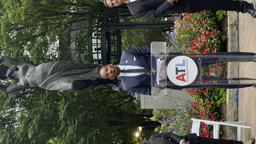 Atlanta Mayor Andre Dickens speaks at a press conference in Woodruff Park on Tuesday, Sept. 3, 2024. Cathryn Vassell, CEO of Partners for Home, and Frank Fernandez, President and CEO at Community Foundation for Greater Atlanta, stand beside him. (AP Photo/Charlotte Kramon)