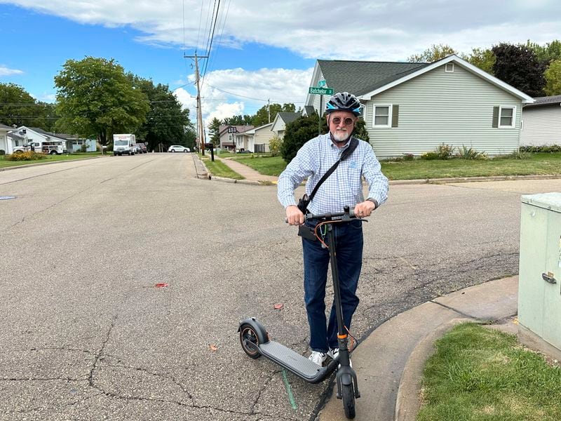 Wisconsin legislative candidate Scott Abbot Walker prepares to ride his scooter during door-to-door campaign stops in Platteville, Wis., on Friday, Sept. 6, 2024. Walker is trying to differentiate himself on the campaign trail from Wisconsin's former governor, Republican Scott Walker. (AP Photo/Todd Richmond)