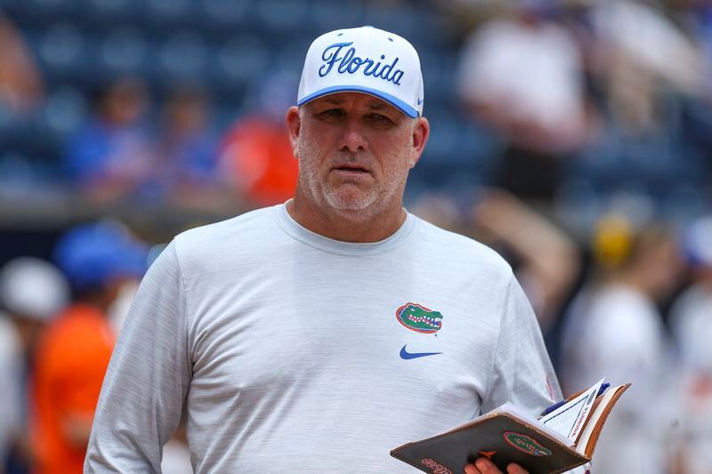 Florida coach Tim Walton meets with officials before the team's NCAA college softball tournament game against Florida Gulf Coast, Friday, May 17, 2024, in Gainesville, Fla. (AP Photo/Gary McCullough)