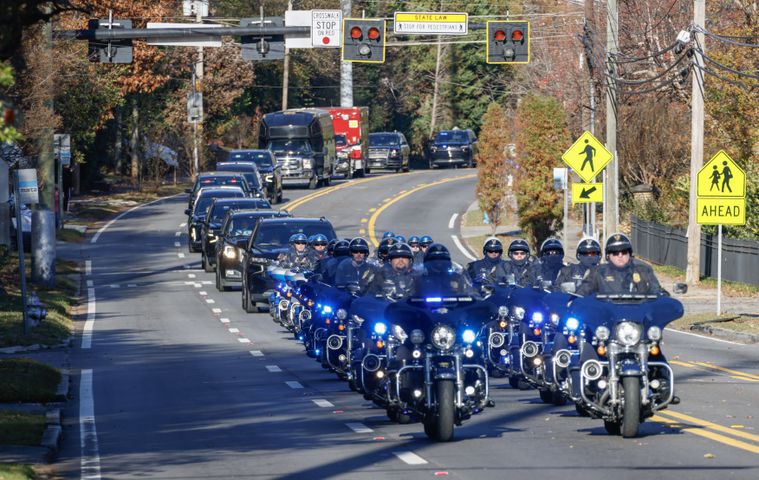 The motorcade carrying former first lady Rosalynn Carter makes it's way down Briarcliff Road In Atlanta following services at Glenn Memorial Church on Tuesday, Nov. 28, 2023.   (Bob Andres for the Atlanta Journal Constitution)