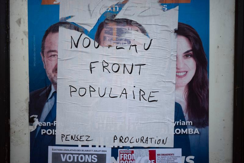 An electoral campaign board is set up in the countryside for the upcoming parliamentary elections, in Lachassagne, central France, Tuesday, June 25, 2024. The upcoming two-round parliamentary election will take place on June 30 and July 7. (AP Photo/Laurent Cipriani)