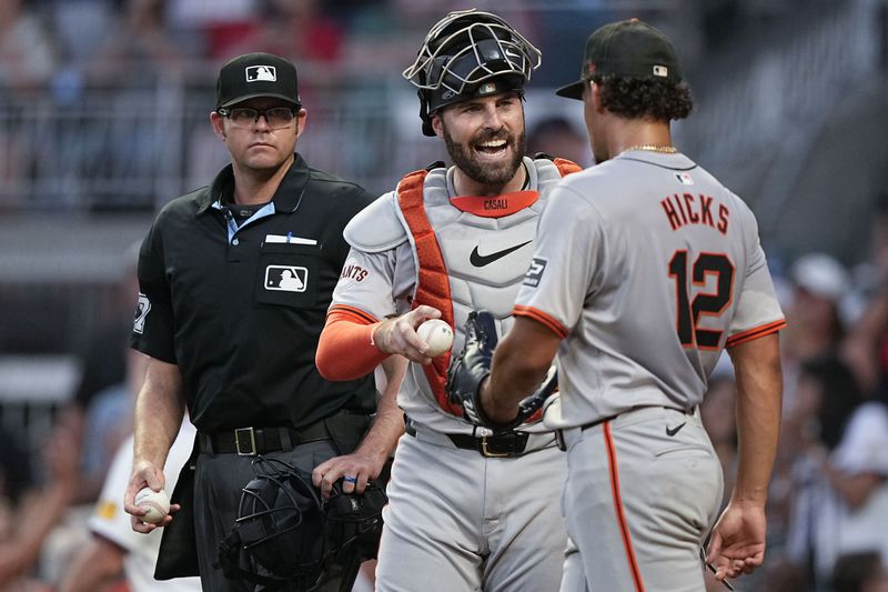 San Francisco Giants catcher Curt Casali (18) talks to San Francisco Giants catcher Curt Casali (18) after tagging out Atlanta Braves' Austin Riley (27) at home in the fifth inning of a baseball game, Wednesday, July 3, 2024, in Atlanta. (AP Photo/Brynn Anderson)