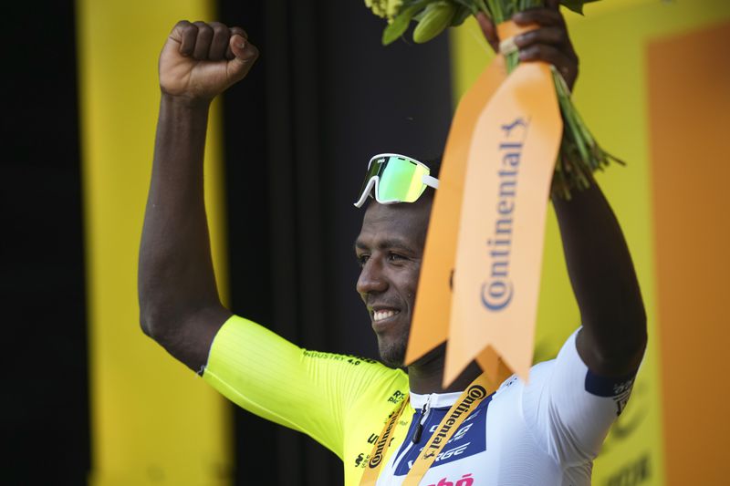 Stage winner Eritrea's Biniam Girmay celebrates on the podium after the third stage of the Tour de France cycling race over 230.8 kilometers (143.4 miles) with start in Piacenza and finish in Turin, Italy, Monday, July 1, 2024. (AP Photo/Daniel Cole)