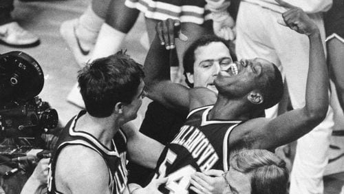 In this April 1, 1985 file photo, Villanova's Ed Pinckney (54) yells out as he is surrounded by teammates after the Wildcats defeated Georgetown for the national championship in the Final Four of the NCAA college basketball tournament in Lexington, Ky. (AP Photo/Gary Landers, File)