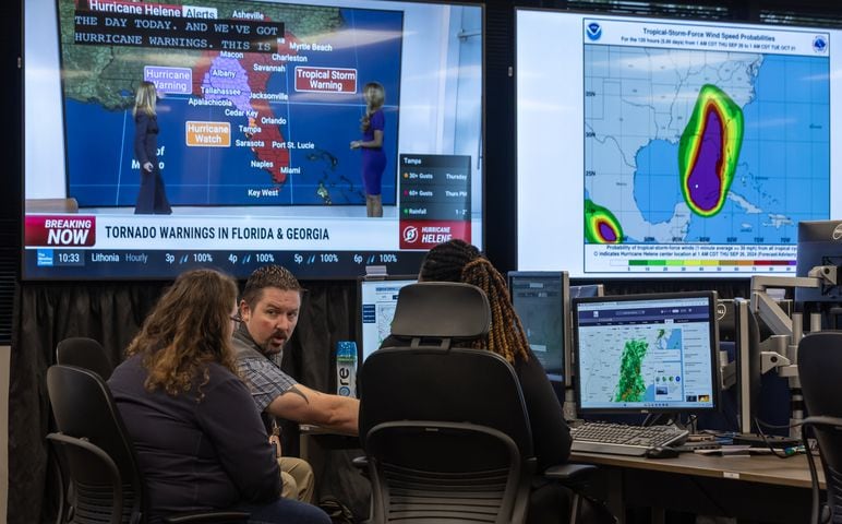 Michelle Ellis, left to right, Christopher Schneider and Ashley Johnson coordinate resources on Thursday, Sept. 26, 2024 at the FEMA Regional Response Coordination Center in DeKalb County. According to the National Oceanic and Atmospheric Administration, Helene’s wind field is expected to extend 345 miles from its center. That’s farther than the distance from Atlanta to Savannah and means areas far from the eye will still face damaging winds. Helene’s rain bands will stretch even farther from the center. -- Text by Drew Kann/AJC. (Photo by John Spink/AJC)