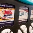 FILE - A Mega Millions logo is displayed on a vending machine at the Hoosier Lottery booth at the Indiana State Fair, Thursday, Aug. 3, 2023, in Indianapolis. (AP Photo/Darron Cummings, File)