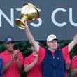 United States team captain Jim Furyk hoist the Presidents Cup as Canada Prime Minister Justin Trudeau looks on at Royal Montreal Golf Club on Sunday, Sept. 29, 2024, in Montreal. (Frank Gunn/The Canadian Press via AP)