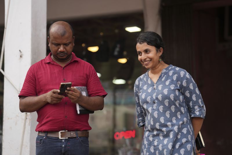 Swasthika Arulingam, right, 37, a human rights lawyer and a minority Tamil, who offered legal aid to protesters during the uprising, talks to Nuwan Bopage, a presidential candidate from People's Struggle Alliance during an election campaign in Colombo, Sri Lanka, Monday, Sept. 16, 2024. (AP Photo/Rajesh Kumar Singh)