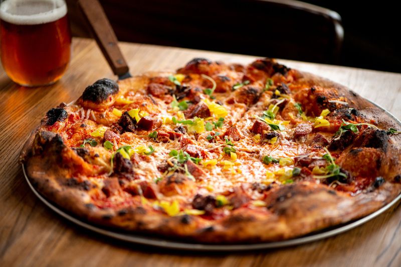 The Hell Boy pizza features tomato, chili garlic sauce, mozzarella, provolone, pepperoni, soppressata, Calabrian chiles, pepperoncini and basil. Mia Yakel for The Atlanta Journal-Constitution