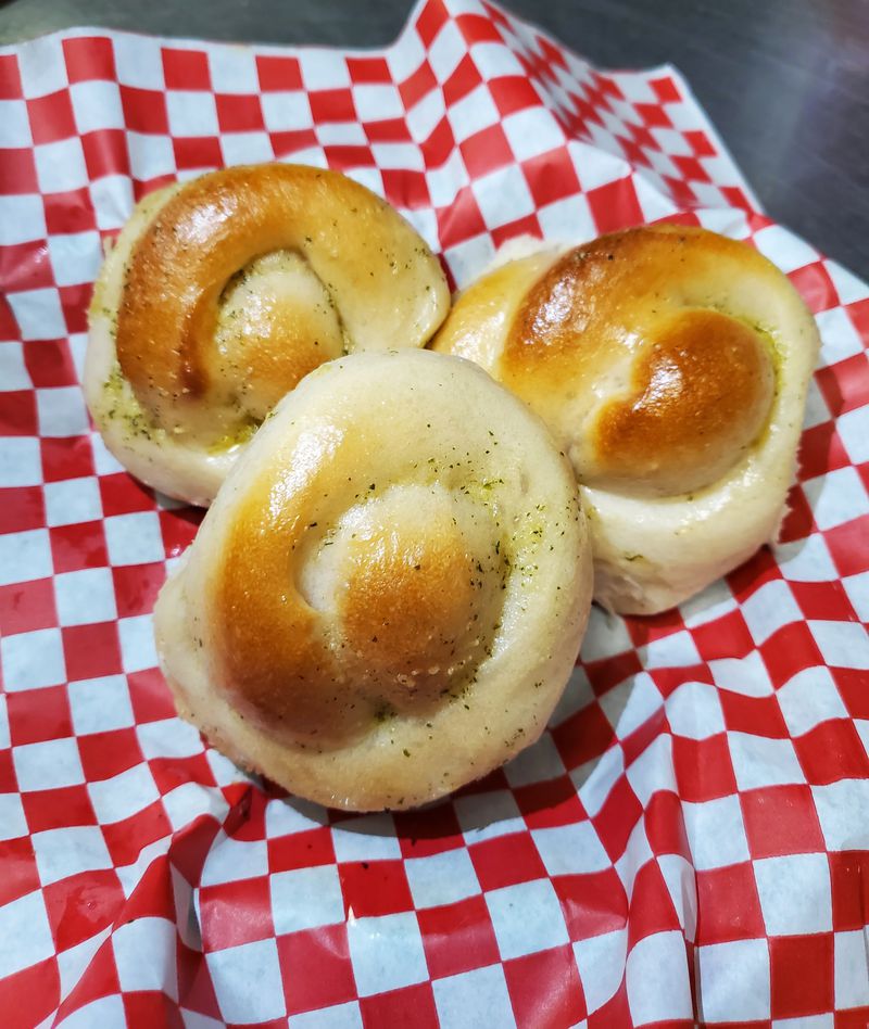 Bambinelli's garlic knots are extra soft, pillowy, golden brown and smothered in melted garlic butter. Courtesy of Haley Gentile