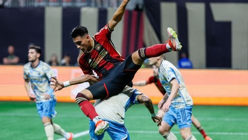 Atlanta United forward Tyler Wolff (28) landed on Philadelphia Union defender Damion Lowe (17) on a play by the box during the first half against the Philadelphia Union on Sunday, April 14, 2024.
 Miguel Martinez / miguel.martinezjimenez@ajc.com