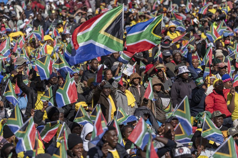South Africans cheer ahead of the inauguration of South Africa's Cyril Ramaphosa as President at the Union Buildings South Lawns in Tshwane, South Africa, Wednesday, June 19, 2024. (AP Photo/Jerome Delay)