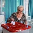 A Tunisian voter casts her ballot at a polling station during the presidential elections, in the capital Tunis, Tunisia, Sunday, Oct. 6, 2024. (AP Photo/Anis Mili)