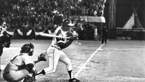 Third base sits in the background as Henry Aaron begins the swing that broke Babe Ruth's career home run record. Billy Downs / AJC