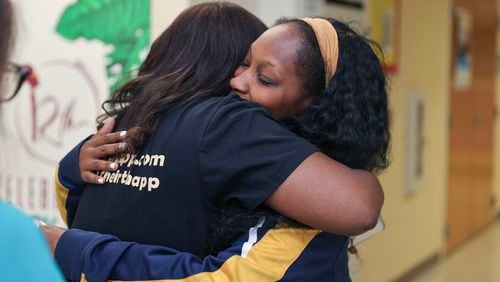 (Left to right) Kimberly Seals Allers, creator of an app called Irth hugs Joquita Hill after listening to her birth story during a launch event at Sheltering Arms Educare Center in Atlanta on Thursday, June 15, 2023. The app is  “Yelp-like” review and rating platform for Black mothers to share birthing experiences to help make Black birth safer. (Natrice Miller/ Natrice.miller@ajc.com)