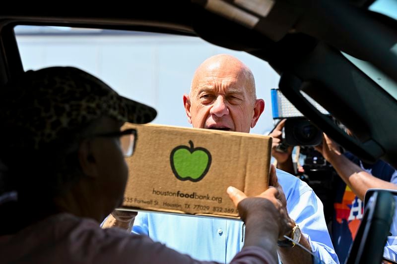 Houston Mayor John Whitmire helps handing out food boxes at Acres Homes cooling center in Houston, Wednesday, July 10, 2024. After Hurricane Beryl slammed into Texas, the storm knocked out power to nearly 3 million homes and businesses. (AP Photo/Maria Lysaker)