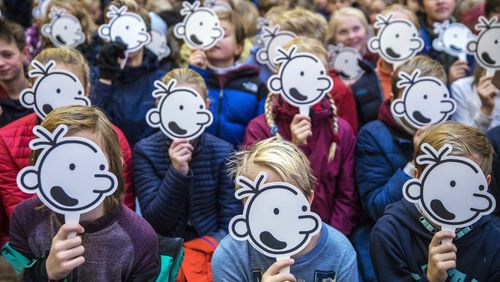 FILE - Children hold up masks of the face of fictional character Greg Heffley during a gathering with the US cartoonist Jeff Kinney, at the publishing house Gyldendal in Oslo, Norway, on Nov. 29, 2018. Norway has tightened controls over adoptions from abroad but will allow the practice to continue as it conducts an investigation into the legality and ethics of past adoptions, the government said Wednesday, June 19, 2024. (Ole Berg-Rusten/NTB scanpix via AP)