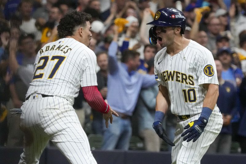 Milwaukee Brewers' Sal Frelick celebrates his home run with Willy Adames during the seventh inning of Game 3 of a National League wild card baseball game against the New York Mets Thursday, Oct. 3, 2024, in Milwaukee. (AP Photo/Morry Gash)