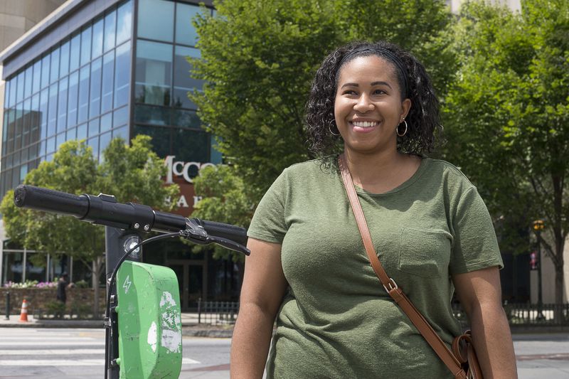 08/20/2019 -- Atlanta, Georgia -- Amber Sanchez of New York answers questions about shareable e-scooters near Centennial Olympic Park in Atlanta, Tuesday, August 20, 2019. (Alyssa Pointer/alyssa.pointer@ajc.com)